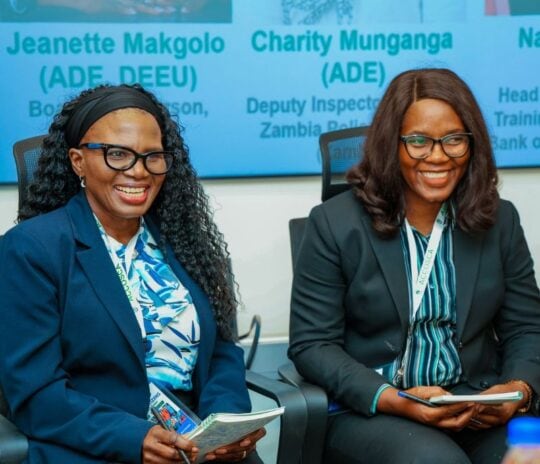 Two women speaking on a panel at the learning event.